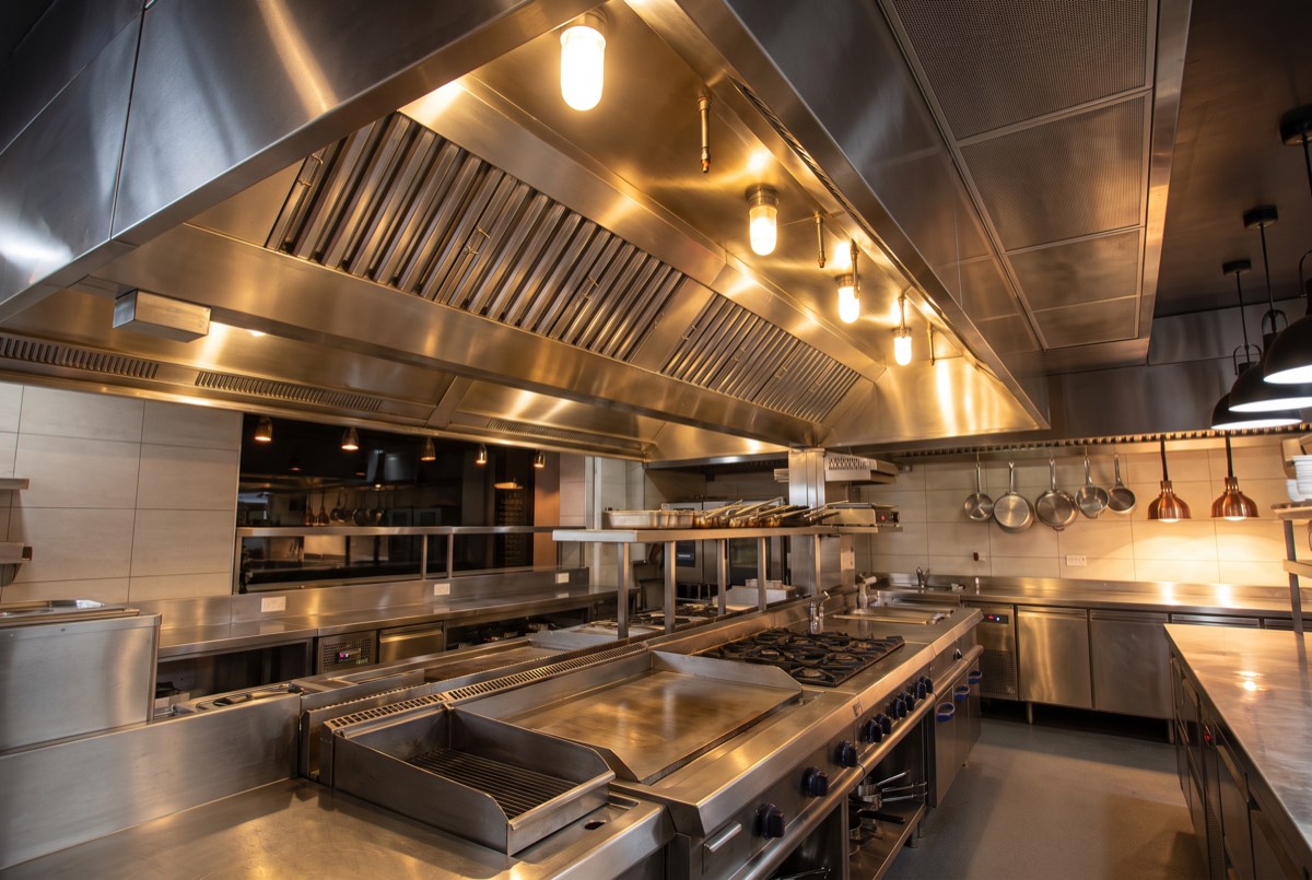 Gleaming clean commercial kitchen line and hood after deep cleaning in Carrollton, TX